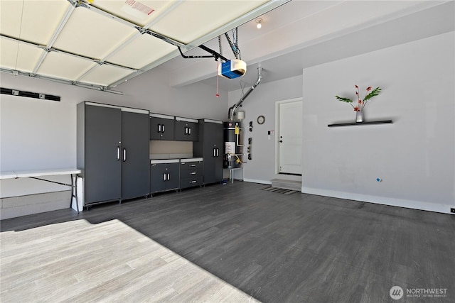 20325 90th Pl S, Kent, WA 98031 - garage with a garage door opener, strapped water heater, and baseboards