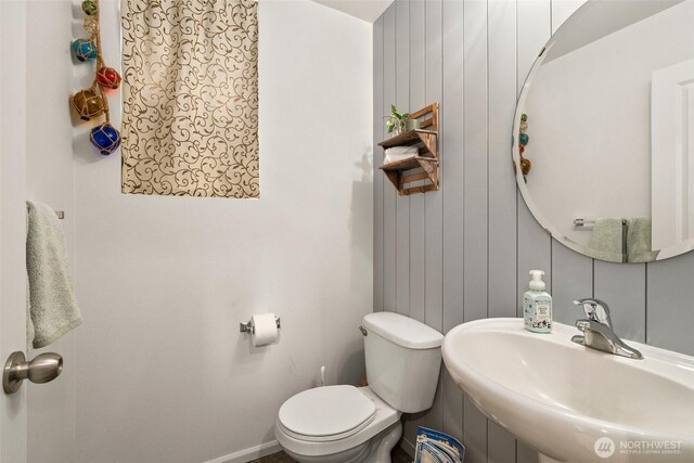 1082 G St SW, Tumwater, WA 98512 - half bath featuring a sink, toilet, and baseboards