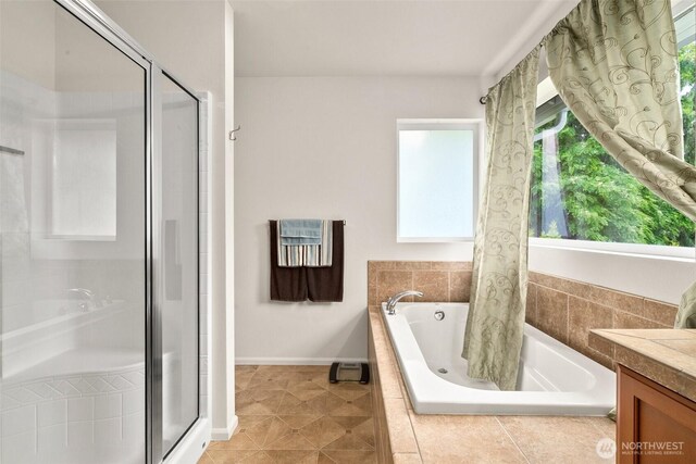 1082 G St SW, Tumwater, WA 98512 - full bath featuring a shower stall, a bath, vanity, tile patterned floors, and baseboards