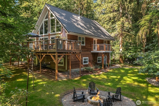 27603 145th Ave SW, Vashon, WA 98070 - back of property with a fire pit, a yard, a wooden deck, metal roof, and stairs