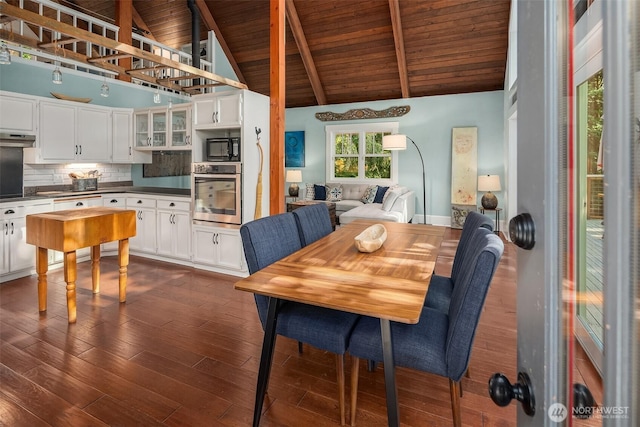 27603 145th Ave SW, Vashon, WA 98070 - dining area with wooden ceiling with exposed beams, dark wood finished floors, and high vaulted ceiling