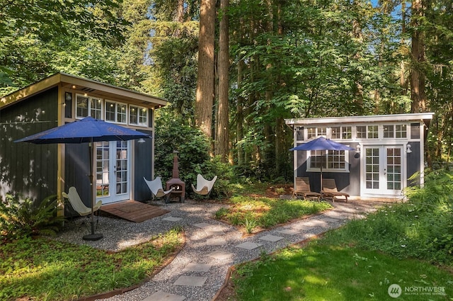 27603 145th Ave SW, Vashon, WA 98070 - view of yard featuring french doors, an outdoor structure, and a view of trees