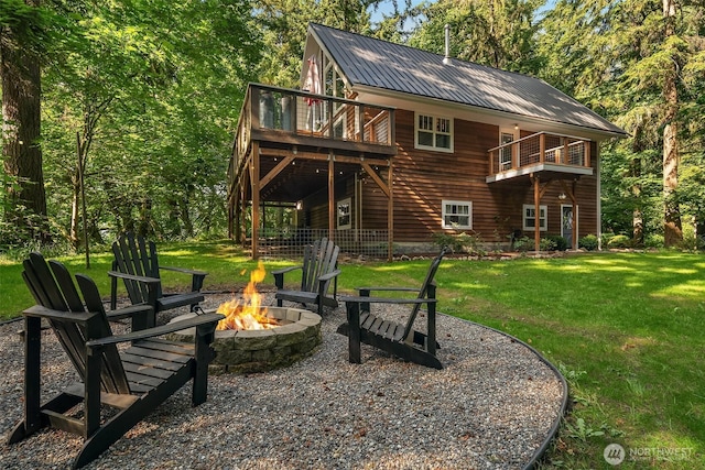 27603 145th Ave SW, Vashon, WA 98070 - back of house featuring an outdoor fire pit, a lawn, a deck, and metal roof