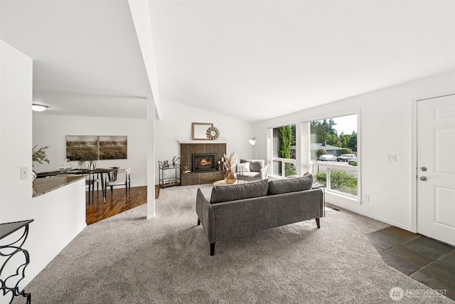 35639 12th Ave SW, Federal Way, WA 98023 - living room with carpet, vaulted ceiling, a tiled fireplace, and baseboards