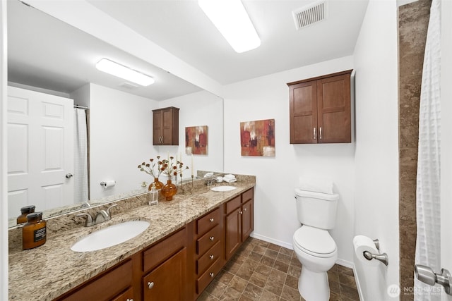 35639 12th Ave SW, Federal Way, WA 98023 - full bathroom with baseboards, double vanity, toilet, and stone finish floors
