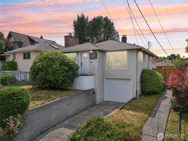 3007 23rd Ave S, Seattle, WA 98144 - view of front facade featuring concrete driveway, a chimney, a garage, and stucco siding