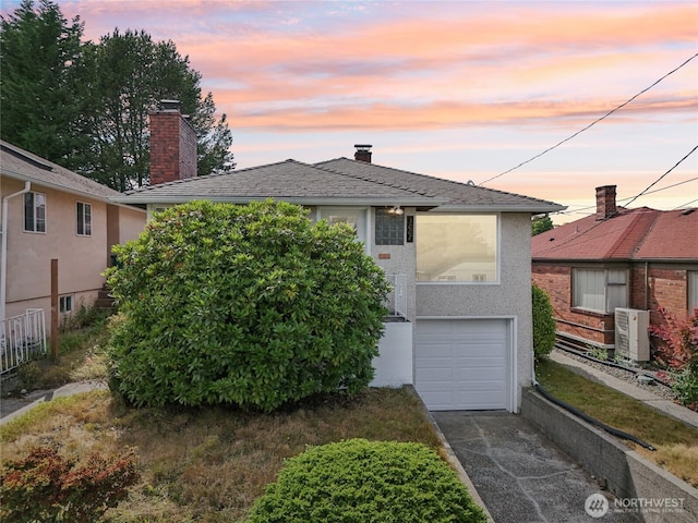 3007 23rd Ave S, Seattle, WA 98144 - view of front of house featuring driveway, a chimney, a garage, and stucco siding