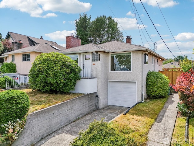 3007 23rd Ave S, Seattle, WA 98144 - view of front facade featuring a chimney, a garage, driveway, and stucco siding