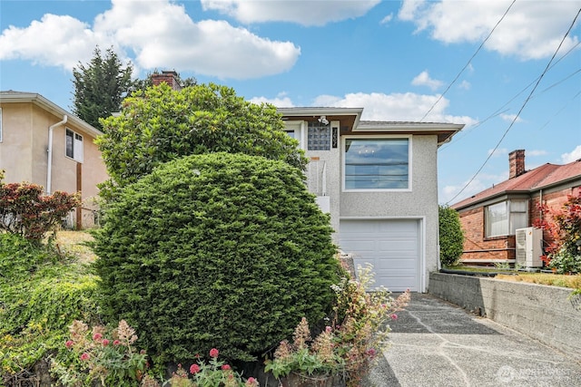 3007 23rd Ave S, Seattle, WA 98144 - view of front facade with concrete driveway, an attached garage, and stucco siding