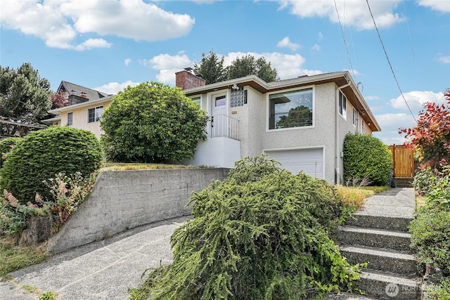 3007 23rd Ave S, Seattle, WA 98144 - view of front of house with a garage, stucco siding, and a chimney
