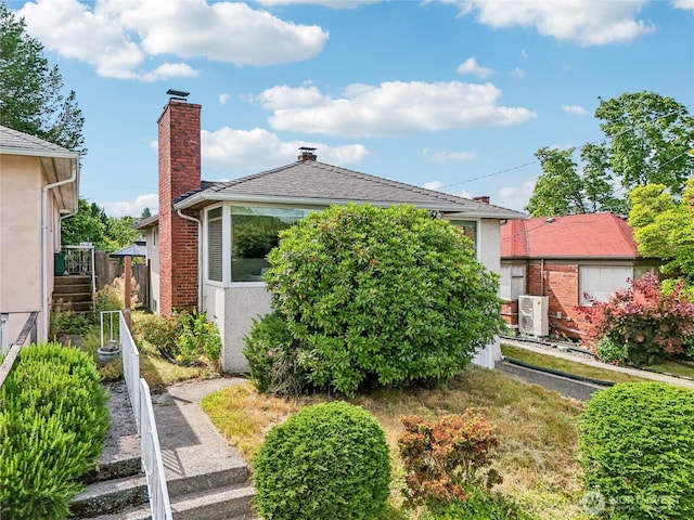 3007 23rd Ave S, Seattle, WA 98144 - view of property exterior featuring a chimney, stairs, and brick siding