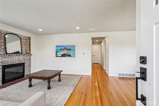 3007 23rd Ave S, Seattle, WA 98144 - living area with a textured ceiling, light wood-type flooring, a fireplace, and recessed lighting