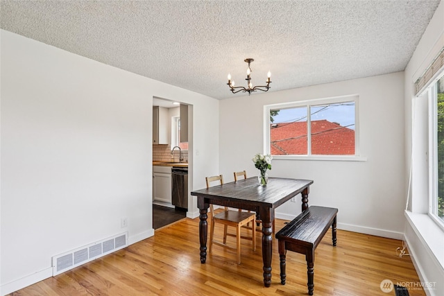 3007 23rd Ave S, Seattle, WA 98144 - dining area featuring a chandelier, light wood-style floors, and a textured ceiling