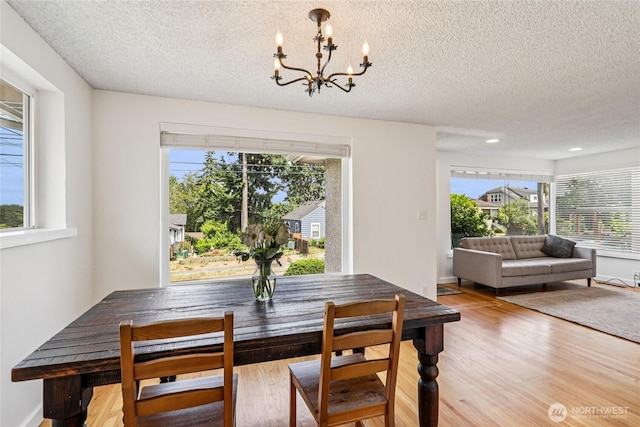 3007 23rd Ave S, Seattle, WA 98144 - dining room with a chandelier, a textured ceiling, plenty of natural light, and wood finished floors