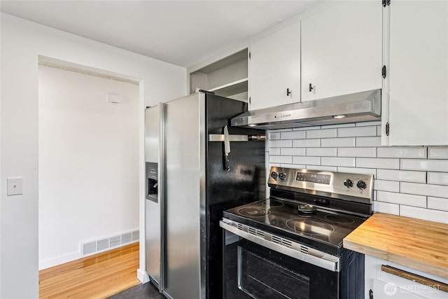 3007 23rd Ave S, Seattle, WA 98144 - kitchen featuring appliances with stainless steel finishes, under cabinet range hood, tasteful backsplash, butcher block counters, and white cabinets