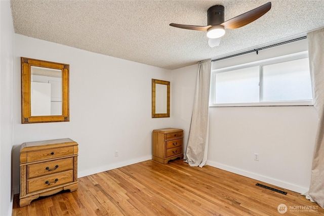 3007 23rd Ave S, Seattle, WA 98144 - unfurnished bedroom featuring a textured ceiling, light wood-style flooring, and ceiling fan