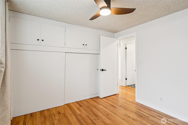 3007 23rd Ave S, Seattle, WA 98144 - unfurnished bedroom featuring light wood-style floors, a textured ceiling, a closet, and ceiling fan