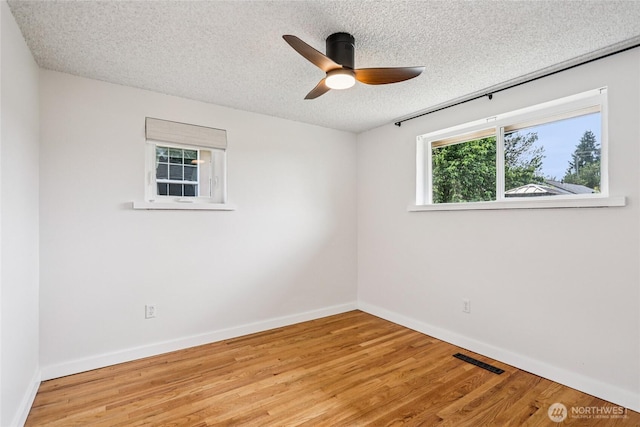 3007 23rd Ave S, Seattle, WA 98144 - unfurnished room with a textured ceiling, wood finished floors, and a ceiling fan