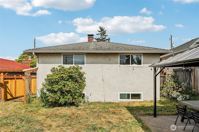 3007 23rd Ave S, Seattle, WA 98144 - back of house featuring stucco siding, a chimney, and a patio