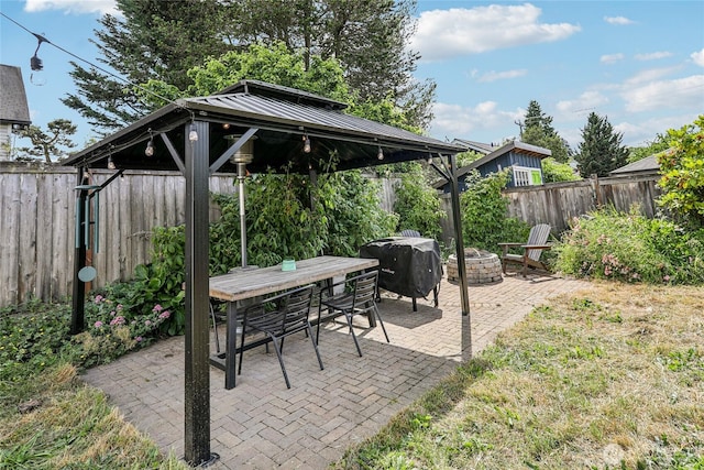 3007 23rd Ave S, Seattle, WA 98144 - fenced backyard featuring a gazebo, a fire pit, a patio, area for grilling, and outdoor dining area