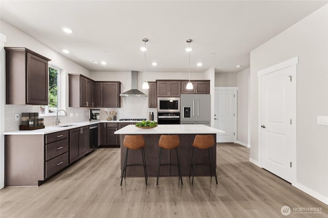 3704 98th Avenue Ct E Unit 1, Edgewood, WA 98371 - kitchen featuring stainless steel appliances, wall chimney exhaust hood, dark brown cabinets, decorative backsplash, and recessed lighting