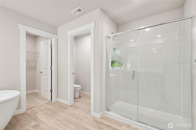 3704 98th Avenue Ct E Unit 1, Edgewood, WA 98371 - full bathroom featuring a shower stall, wood finished floors, and a walk in closet