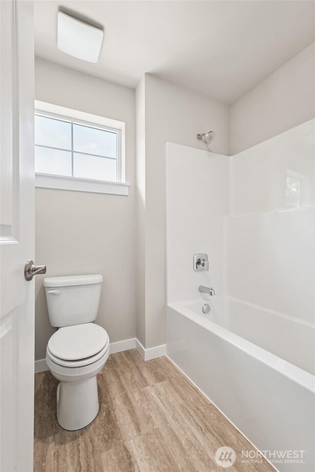 3704 98th Avenue Ct E Unit 1, Edgewood, WA 98371 - full bath featuring wood finished floors and bathing tub / shower combination