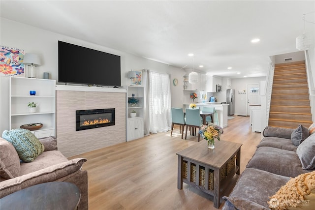 3628S Sheridan Ave, Tacoma, WA 98418 - living room with light wood-type flooring, stairway, recessed lighting, and a fireplace