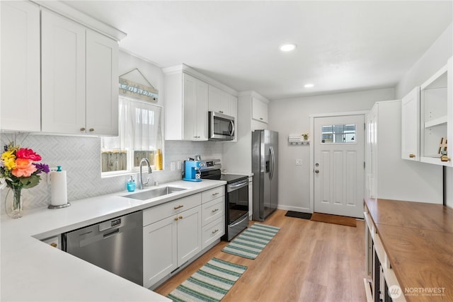 3628S Sheridan Ave, Tacoma, WA 98418 - kitchen featuring appliances with stainless steel finishes, a sink, plenty of natural light, white cabinets, and recessed lighting