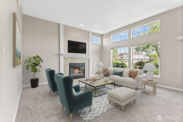 1933 Windflower Ln SE, Lacey, WA 98503 - carpeted living area with baseboards, a tiled fireplace, a textured ceiling, and recessed lighting