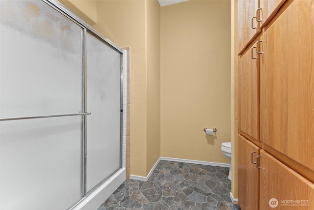 1933 Windflower Ln SE, Lacey, WA 98503 - bathroom featuring toilet, a shower stall, and baseboards
