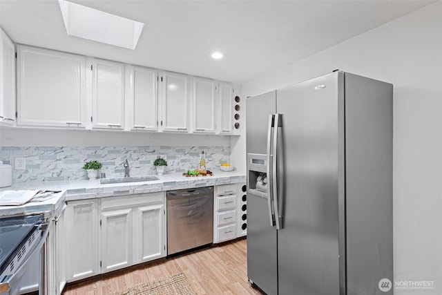 14600 SE 176th St Unit H11, Renton, WA 98058 - kitchen featuring appliances with stainless steel finishes, a sink, light countertops, white cabinets, and recessed lighting