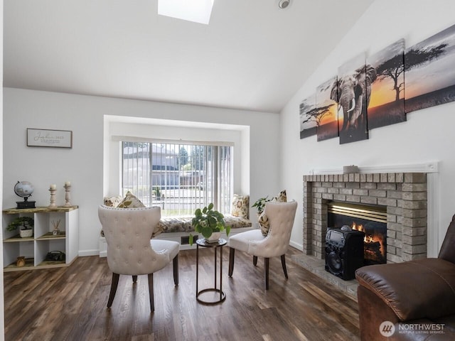 4715 247th St E, Graham, WA 98338 - sitting room featuring a brick fireplace, wood finished floors, vaulted ceiling, baseboards, and a skylight