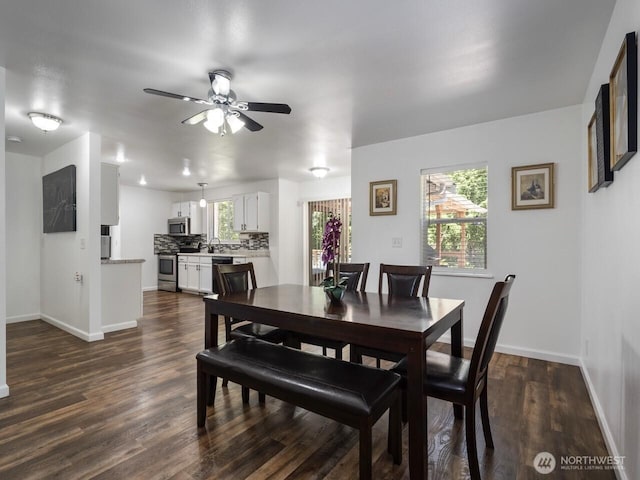 4715 247th St E, Graham, WA 98338 - dining room featuring a ceiling fan, baseboards, and dark wood finished floors