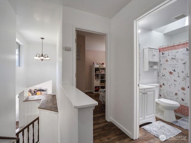 4715 247th St E, Graham, WA 98338 - corridor featuring dark wood-style floors and a chandelier