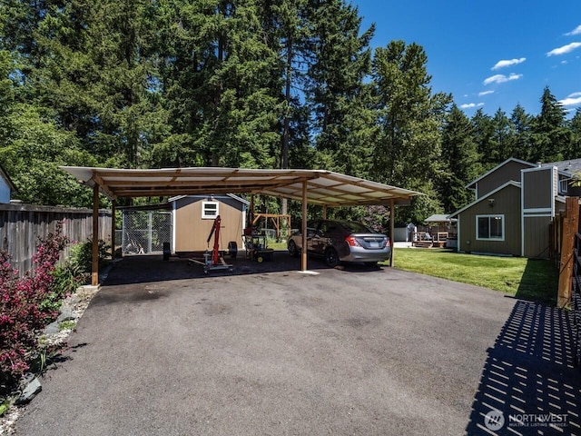 4715 247th St E, Graham, WA 98338 - view of parking / parking lot featuring a carport, a shed, and asphalt driveway