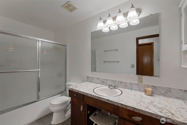 6201 47th Ave S, Seattle, WA 98118 - full bathroom with vanity, toilet, and shower / bath combination with glass door
