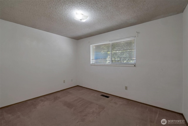 6201 47th Ave S, Seattle, WA 98118 - carpeted empty room featuring a textured ceiling and baseboards