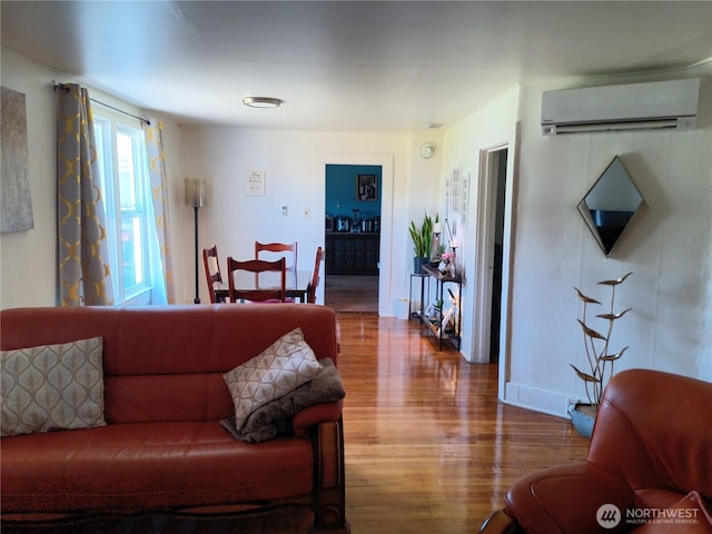 226 Eklund Ave, Hoquiam, WA 98550 - living room with an AC wall unit, wood finished floors, and baseboards