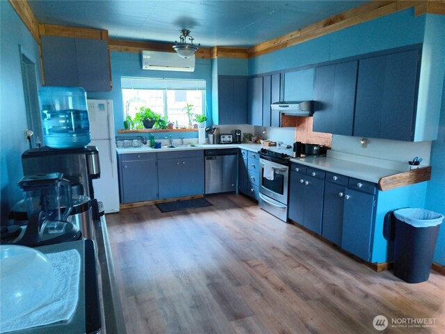 226 Eklund Ave, Hoquiam, WA 98550 - kitchen with stainless steel appliances, a wall mounted air conditioner, ventilation hood, and light countertops
