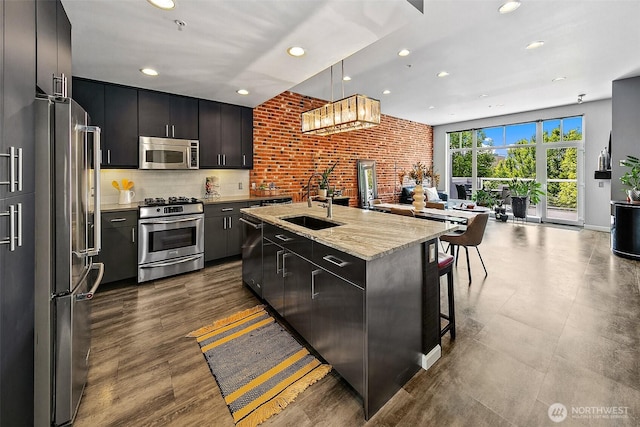 17 W Mercer St Unit 302, Seattle, WA 98119 - kitchen featuring stainless steel appliances, open floor plan, a sink, recessed lighting, and a kitchen bar