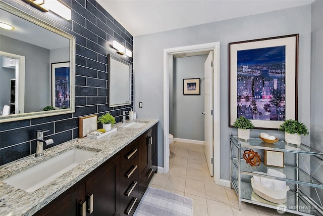 17 W Mercer St Unit 302, Seattle, WA 98119 - full bathroom with double vanity, toilet, tile patterned floors, baseboards, and tasteful backsplash