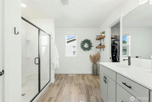 17314 SE 254th Pl, Covington, WA 98042 - bathroom featuring a stall shower, plenty of natural light, vanity, and a walk in closet