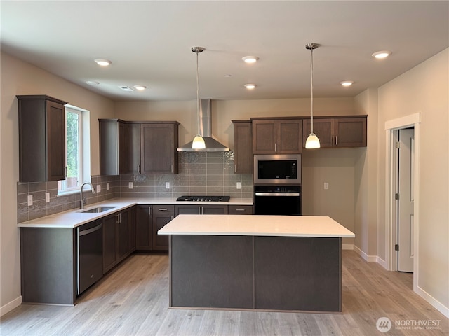 3905 98th Avenue Ct E Unit 33, Edgewood, WA 98371 - kitchen with appliances with stainless steel finishes, wall chimney exhaust hood, light countertops, a center island, and recessed lighting