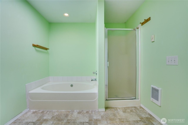 10513 SE 250th Pl Unit F-106, Kent, WA 98031 - bathroom with heating unit, a stall shower, a bath, and recessed lighting