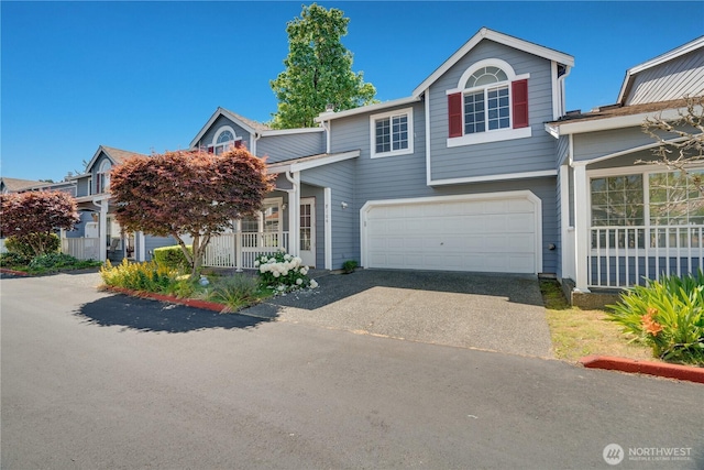 10513 SE 250th Pl Unit F-106, Kent, WA 98031 - view of front of house featuring driveway, an attached garage, and a porch