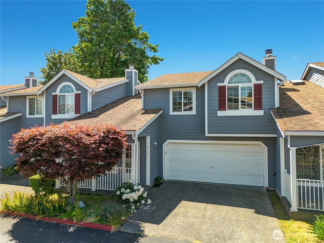 10513 SE 250th Pl Unit F-106, Kent, WA 98031 - view of front of home with a chimney, roof with shingles, concrete driveway, and an attached garage