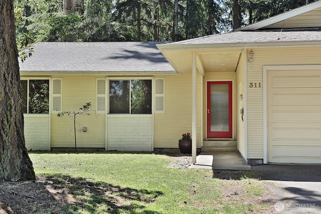 311 Edgecliff Dr, Langley, WA 98260 - property entrance with a yard, a shingled roof, and an attached garage
