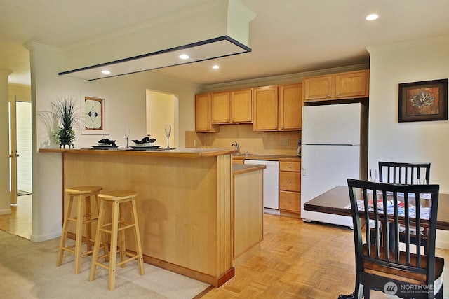 311 Edgecliff Dr, Langley, WA 98260 - kitchen featuring white appliances, ornamental molding, a breakfast bar, recessed lighting, and baseboards