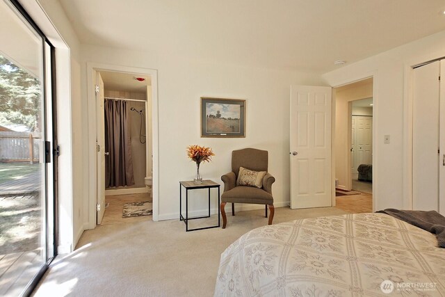 311 Edgecliff Dr, Langley, WA 98260 - bedroom with light colored carpet, ensuite bath, baseboards, and access to exterior